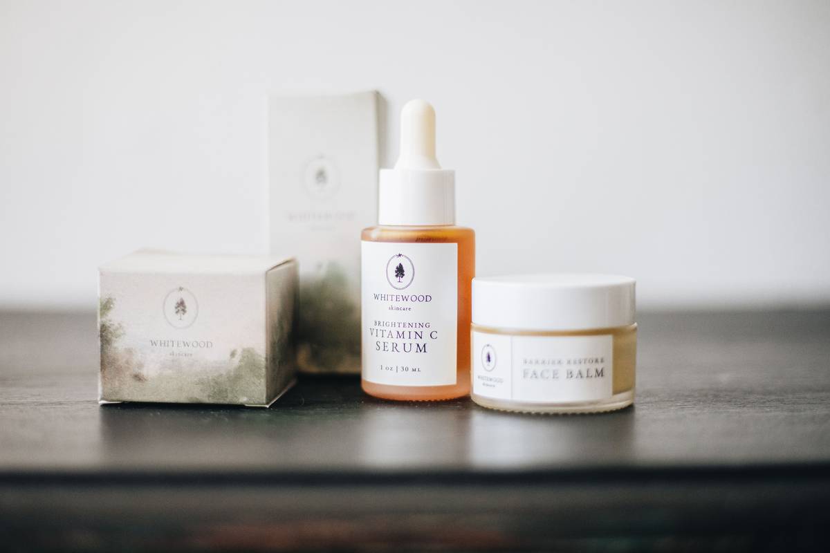 Hand applying soft and sensual creamy body balm to forearm, showing smooth absorption and luminous finish