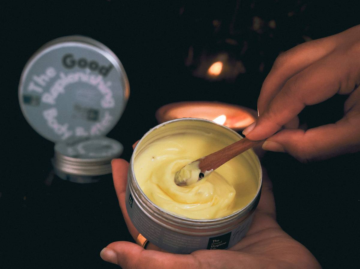Woman applying hydrating cream balm can i use to dry elbows after shower
