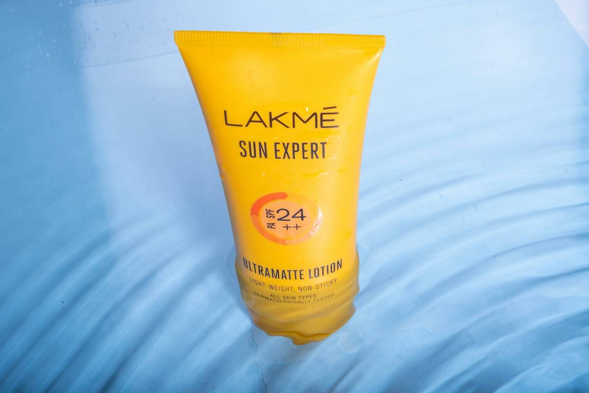 Jar of amber-tinted everything balm skin protection applied to dry elbows showing immediate smoothing effect